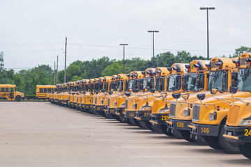 Idle school buses await the reopening of K-12 schools