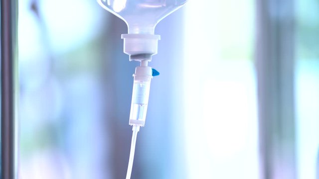 Closeup of IV drip in hospital, Intravenous saline solution, IV loading dose in ER room.