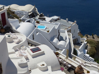 White architecture and blue domes in Oia, Santorini island, Thira, Cyclades islands, Greece.