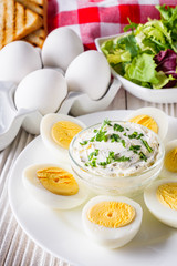 boiled chicken eggs on a white wooden rustic background