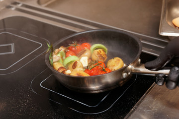 Stirring vegetables in pan