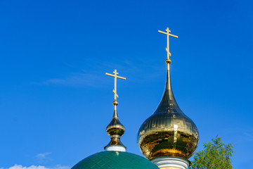 domes of an orthodox temple made of golden metal