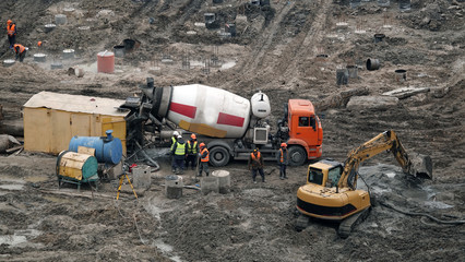 Workers and machinery - zero-cycle construction of the foundation of an entertainment center
