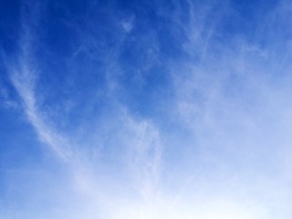 White cirrus clouds formations on blue sky, texture background