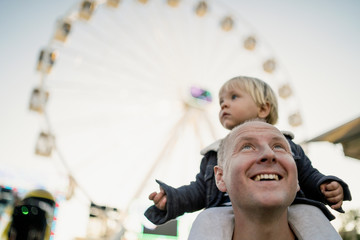 Happy father with his little son in an amusement park