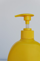 yellow plastic bottle with liquid soap