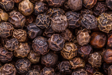 fragrant black pepper on white acrylic background