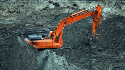 Tractors and excavators work on the construction of the foundation zero cycle