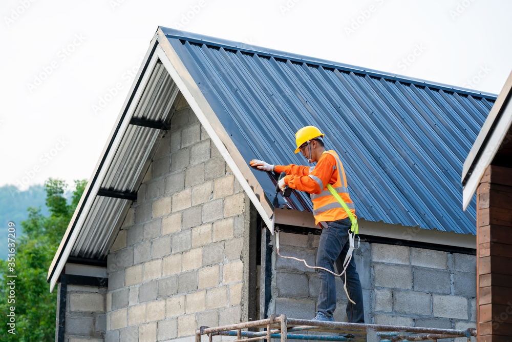 Aufkleber roofer wearing safety harness belt during working on roof structure of building on construction site