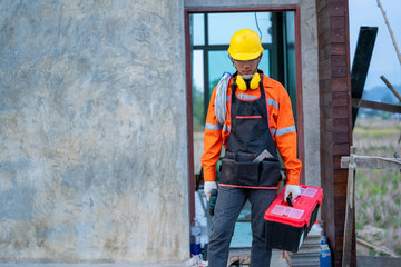 Electrician working with tool at the construction site,House and house reconstruction.