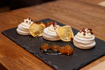 Meringue dessert with orange chips and leechee jam