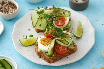 Healthy Breakfast with Wholemeal Bread Toast and Egg with Green Salad, Avocado and Peas.