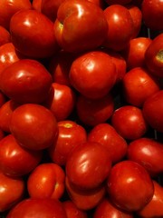 red tomatoes at the market. Stack of Fresh tomatoes. Top view. It can be used as background. Delicious red tomato.