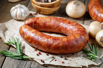 Smoked sausage on a wooden table. Rustic style.
