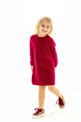 Cute Blonde Little Girl Standing and Smiling at Camera