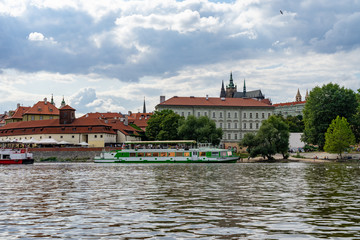 Scenic panorama cityscape view of Moldava river boat Prague in Czech Republic.