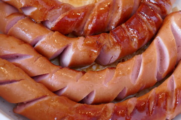 German sausages on the grill, fry sausages.