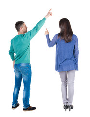 Back view of couple in sweater pointing.