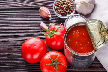 juicy canned tomatoes on wooden rustic background