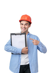 Builder in helmet smiles and point to notepad, isolated, vertical