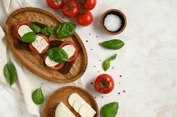 toast tomato basil cheese healthy food on a white table