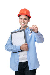 Happy builder in helmet shows keys, isolated background, vertical