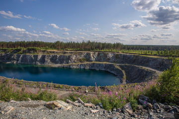 Flooded open pit chromium chrome ore quarry mine with blue water