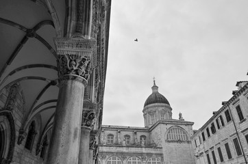 Bell tower and columns of famous church or cathedral in ancient old town of Dubrovnik, Croatia with...