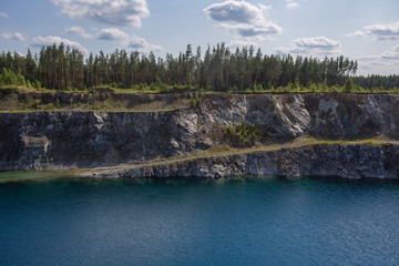 Flooded open pit chromium chrome ore quarry mine with blue water
