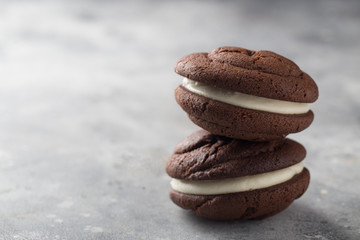 Chocolate whoopie pies on gray stone background