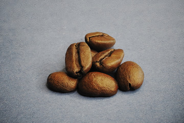 Coffee beans on a purple uneven background