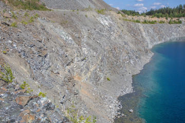 Flooded open pit chromium chrome ore quarry mine with blue water