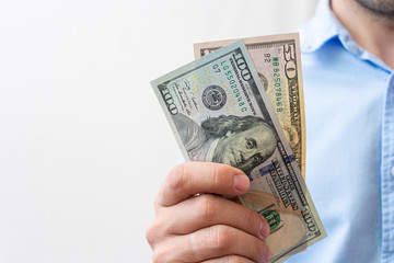 Man shows dollars, american banknotes, men's hands, close-up