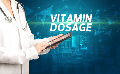 doctor writes notes on the clipboard with VITAMIN DOSAGE inscription, medical diagnosis concept