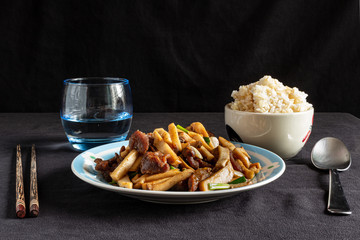 Dish of sun dried fried pork served with mushroom and spring onion, in Thai style.