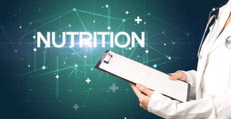 Doctor fills out medical record with NUTRITION inscription, medical concept