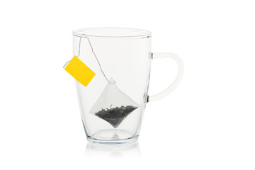 Empty glass with a tea bag isolated on a white background.