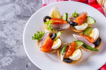delicious snack tartlets on dark stone background