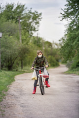 A person riding a bike down a dirt road