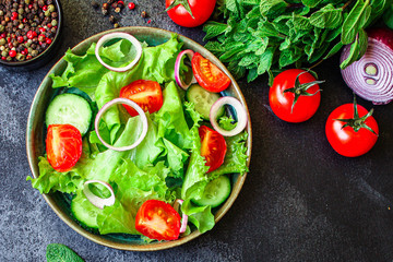 healthy salad (tomato, cucumber, mix leaves other ingredients) top menu concept. food background. copy space keto or paleo diet