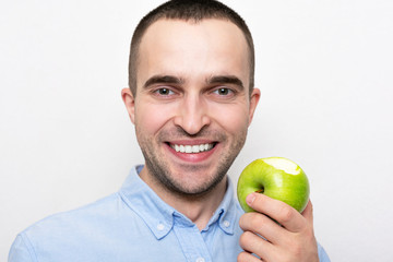 Man with the bitten apple, closeup, cropped image, white background. Concept of a healthy and healthy diet