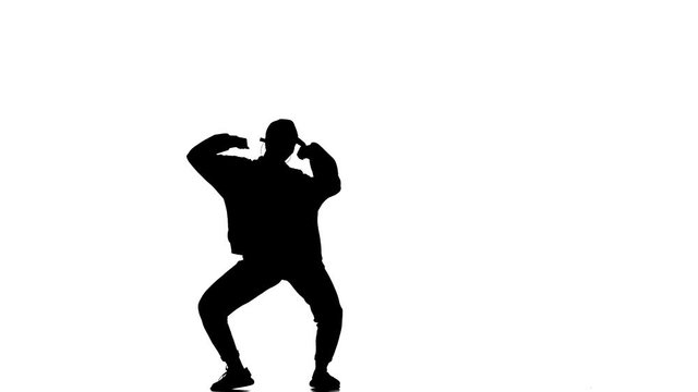 black silhouette on a white background, young beautiful girl dancer in tracksuit and baseball cap dancing hip hop, contemporary, modern street dance, slow motion