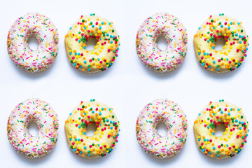 Eight donuts with bright sprinkles on a white background, food concept