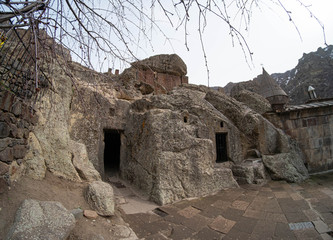 Geghard is a medieval monastery in the Kotayk province of Armenia, being partially carved out of the adjacent mountain, surrounded by cliffs