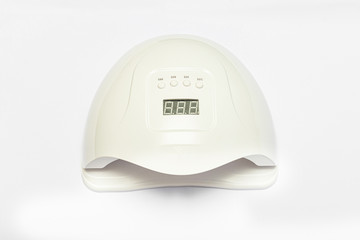 Uv-lamp for attaching gel nails polish, gel method. Led nail, white background, top view