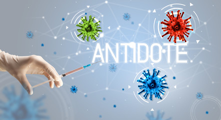 Obraz na płótnie Canvas Syringe, medical injection in hand with ANTIDOTE inscription, coronavirus vaccine concept