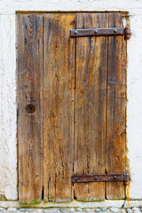 Antique wooden door background. Old iron loops.