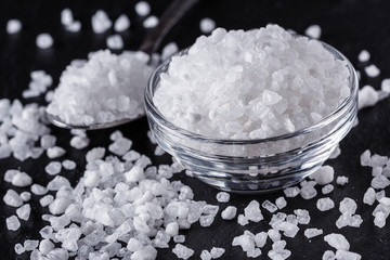 coarse sea salt on a dark stone background