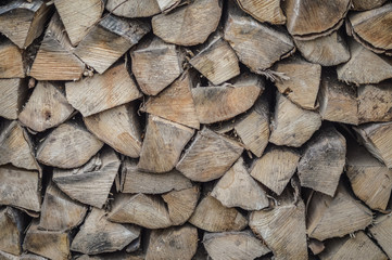 Background of dry firewood - stack of wood