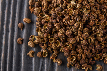 Sichuan pepper on a dark wooden rustic background